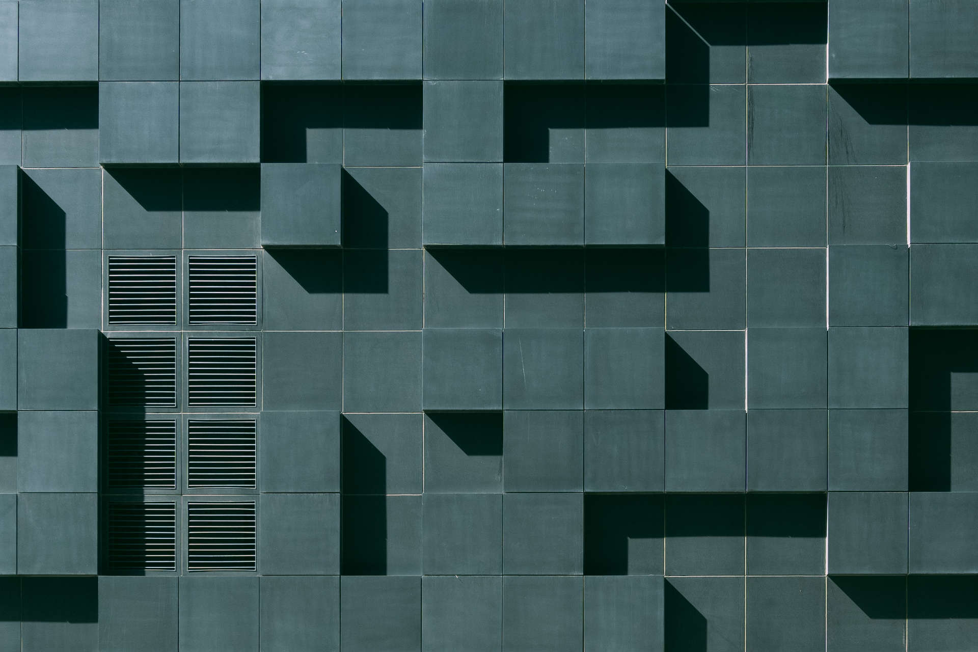 grey concrete building exterior with geometric design